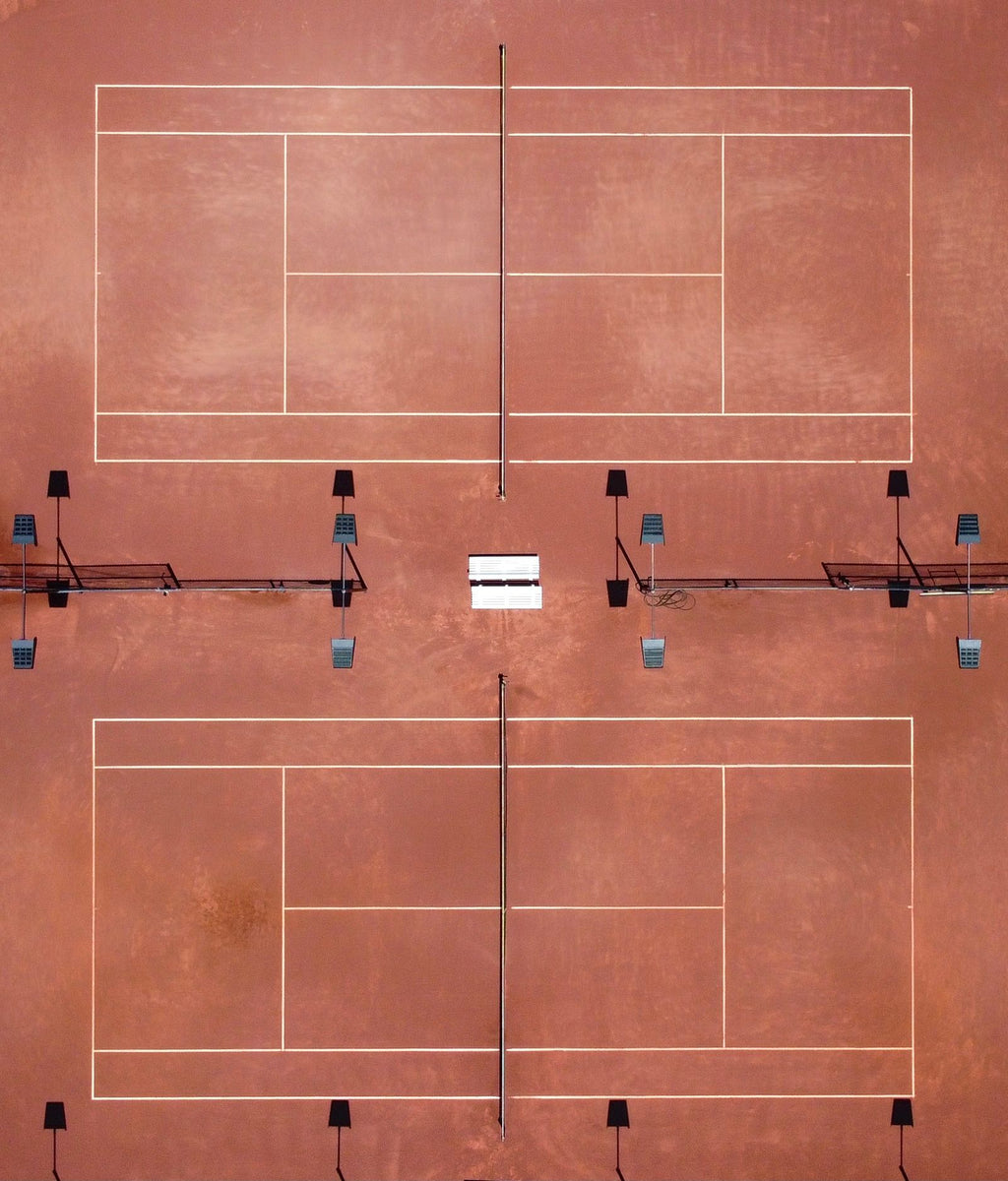 Caliclay brushing tennis court during a red clay court installation or